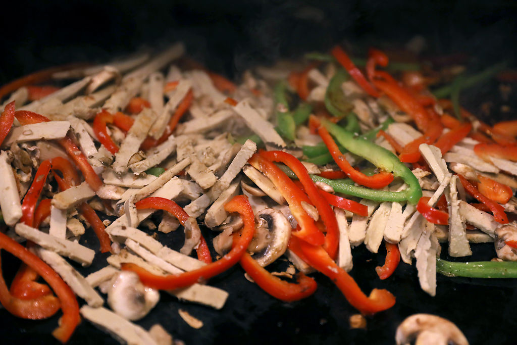 Mushrooms and peppers fry on the grill for quesadillas